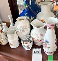 Overall lot showing grouping of porcelain pieces; blue vase visible but excluded