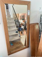 Front view of oak framed rectangular mirror mounted on wall