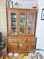 Full view of Vilas china cabinet hutch showing upper glass display section and lower storage section