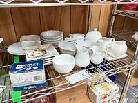 Overview of assorted white porcelain pieces on shelf