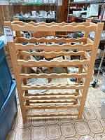Front view of the wood wine rack showing eight tiers and overall structure
