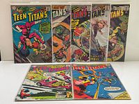 Front view of all seven Teen Titans comics in sleeves