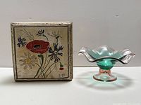 Art glass pedestal dish and signed wooden box side by side