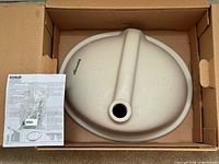 Sink underside in box with instructions and mounting hardware