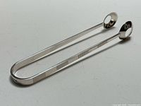 Full view of tongs showing overall form and handle pattern