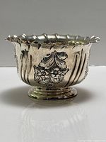 Side view of sterling silver footed bowl showing repoussé decoration