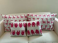 Front view of all four pillows on sofa