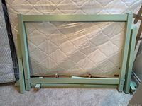 Bed frame components leaned against mattress showing overall design