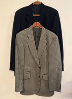 Both blazers hanging together showing overall styles and colors