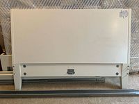 front view of white panel headboard with attached legs and hardware