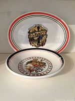 Both Italian ceramic serving pieces together showing motifs and rim stripes