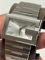 Front view of Gucci G watch held in hand