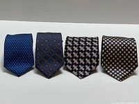 Four neckties laid flat showing full patterns