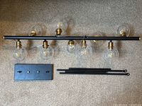 Full view of fixture with seven glass globes, canopy plate and downrods