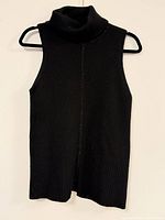 Full frontal view of sleeveless cashmere turtleneck on hanger