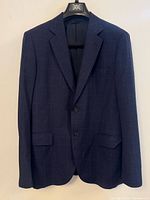 Front view of navy windowpane blazer on hanger