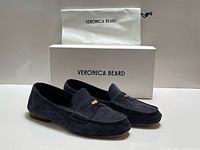 pair of loafers with box and dust bag displayed