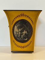 Front view of yellow painted toleware waste basket