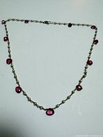 Full view of pearl and pink tourmaline necklace laid flat