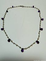 full view of sterling silver necklace with pearls and amethyst drops