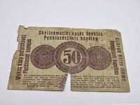 Reverse with large central 50 medallion and multilingual text
