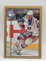 Front of 1997-98 Topps Wayne Gretzky hockey card, showing player image and team logo