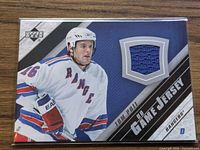Front of card showing player image and blue jersey swatch