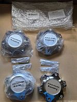 Four wrapped chrome wheel center caps with screws