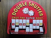 Front view of closed game tin showing branding and tile numbers