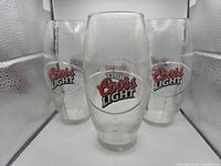 Front view of three Coors Light pint glasses showing logos
