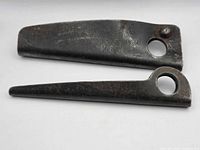 Two steel anchors side by side showing overall form and holes
