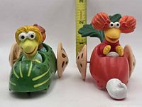 Front view showing both vehicles and characters with ruler for scale