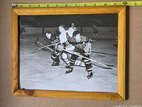 Front view showing entire framed photograph with measuring tape for scale