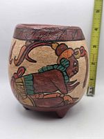 front view showing painted Mayan figure, ruler indicates size under 4 in