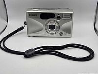 Front view of Konica Z-up 80e camera with wrist strap attached