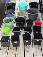 Group shot of all nursery pots and planters laid out on deck