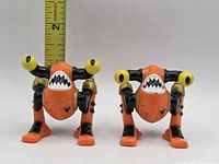 Front view of both Ocula figures with ruler for scale