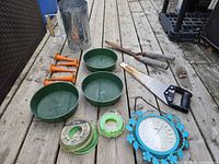 All items laid out: saw, shears, chimney, sieves, stakes, line spools, thermometer