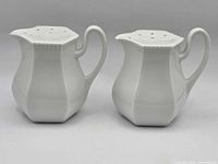 Front view of both porcelain sugar shakers