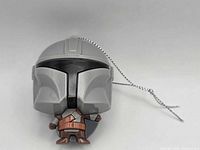 Front view of The Mandalorian vinyl keychain showing helmet details and attached ball chain