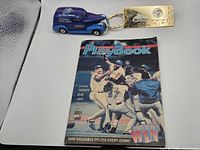 All three items grouped: diecast van keychain, PlayBook magazine, Labatt booklet