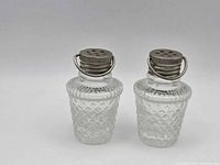 Front view of both shakers showing diamond pattern and metal lids
