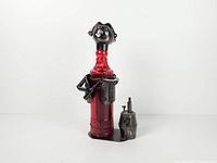 Front view of metal bartender holder with red bottle and barrel cup