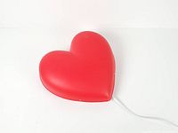 Front view of red heart lamp lying flat showing overall shape and color