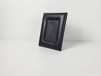 angled view of entire frame showing padded faux leather border and aperture