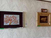 Wall view showing tree painting, abstract painting, and cats composition
