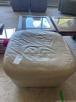 top view of beige ottoman showing overall form and upholstery