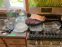overview of all glassware, bar tools, linens on counter and stove