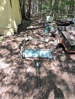 Full view of lawn sweeper frame, brush and tow bar