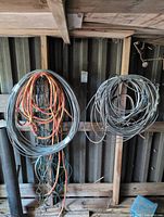 Two large hanging coiled steel cables with multicolor wire bundles